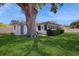 Charming home exterior showcasing a well-maintained lawn and lush landscaping at 2138 Viola Dr, Clearwater, FL 33764