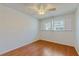 Bedroom featuring hardwood floors and windows with white plantation shutters at 2138 Viola Dr, Clearwater, FL 33764