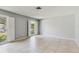 Neutral-toned bedroom featuring tile floors and ample natural light from two large windows at 2138 Viola Dr, Clearwater, FL 33764