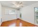 Bedroom featuring hardwood floors and white plantation shutters on windows at 2138 Viola Dr, Clearwater, FL 33764