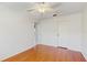 Bedroom with hardwood floors, white walls, ceiling fan and closet door at 2138 Viola Dr, Clearwater, FL 33764