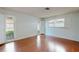 Spacious bedroom with hardwood floors and lots of natural light through large windows at 2138 Viola Dr, Clearwater, FL 33764