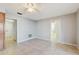 Neutral bedroom with tile flooring, ceiling fan, and access to closet and en-suite bathroom at 2138 Viola Dr, Clearwater, FL 33764
