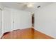 Bright bedroom with hardwood floors, white walls, and plantation shutters on door at 2138 Viola Dr, Clearwater, FL 33764