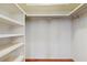 Walk-in closet with white shelving and hardwood floors at 2138 Viola Dr, Clearwater, FL 33764