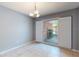 Cozy dining room with tile floors, modern chandelier, and large window with natural light at 2138 Viola Dr, Clearwater, FL 33764