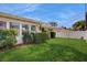 Well-maintained front yard with lush green grass, mature hedges, and a charming, classic home exterior at 2138 Viola Dr, Clearwater, FL 33764