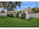 Charming home with a manicured lawn, trimmed hedges, and mature trees providing ample shade at 2138 Viola Dr, Clearwater, FL 33764
