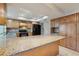 Spacious kitchen featuring wood cabinetry, granite countertops, tile floors and modern appliances at 2138 Viola Dr, Clearwater, FL 33764