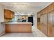 Spacious kitchen featuring wood cabinetry, granite countertops, tile floors and modern appliances at 2138 Viola Dr, Clearwater, FL 33764