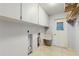 Functional laundry room with ample storage cabinets and utility sink at 2138 Viola Dr, Clearwater, FL 33764
