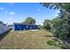Large green backyard featuring a blue house and lots of green space for activities and relaxation at 2426 17Th N Ave, St Petersburg, FL 33713
