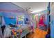 Bright blue bedroom with fun colors, a large bed, and plenty of space for activities and relaxing at 2426 17Th N Ave, St Petersburg, FL 33713