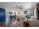 Open-concept living room features stylish ceiling fan, wood floors, and comfortable white leather seating at 2426 17Th N Ave, St Petersburg, FL 33713