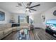 Bright living room with wood floors, white walls, and a modern ceiling fan for a comfortable and stylish living space at 2426 17Th N Ave, St Petersburg, FL 33713
