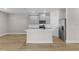 Modern kitchen featuring shaker cabinets, stainless steel appliances, a center island with a sink and laminate floors at 2426 Hiers Rd, Dover, FL 33527