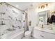 Bathroom featuring white marble style tile, tub, shower, and a modern vanity at 3072 Sugar Bear Trl, Palm Harbor, FL 34684