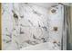 This bathroom features shower with designer tile and gold fixtures at 3072 Sugar Bear Trl, Palm Harbor, FL 34684