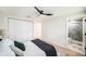 Inviting bedroom with a ceiling fan, comfortable bedding, and an ensuite bathroom at 3072 Sugar Bear Trl, Palm Harbor, FL 34684