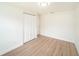 Neutral bedroom with wood-look flooring and a closet at 3072 Sugar Bear Trl, Palm Harbor, FL 34684