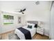 Cozy bedroom with natural light, a ceiling fan, and neutral decor at 3072 Sugar Bear Trl, Palm Harbor, FL 34684