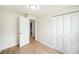 Light-filled bedroom featuring wood-look flooring, closet, and trim at 3072 Sugar Bear Trl, Palm Harbor, FL 34684