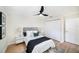 Cozy bedroom with ceiling fan, wood floors, closet and bright white trim at 3072 Sugar Bear Trl, Palm Harbor, FL 34684