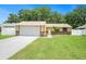 Charming single-story home features a well-manicured lawn and a two-car garage at 3072 Sugar Bear Trl, Palm Harbor, FL 34684