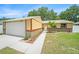 Charming single-story home featuring a well-maintained lawn and a two-car garage at 3072 Sugar Bear Trl, Palm Harbor, FL 34684