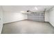 Spacious garage with durable flooring and ample lighting, ready for parking or projects at 3072 Sugar Bear Trl, Palm Harbor, FL 34684