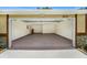 Open garage with epoxy floors, offering plenty of storage and parking space at 3072 Sugar Bear Trl, Palm Harbor, FL 34684