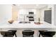 Stylish kitchen with white cabinetry, stainless steel appliances, and a large island with bar seating at 3072 Sugar Bear Trl, Palm Harbor, FL 34684