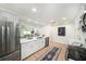 Open-concept kitchen showcasing white cabinetry, stainless steel appliances, and a view into the living area at 3072 Sugar Bear Trl, Palm Harbor, FL 34684