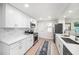 Contemporary kitchen featuring white cabinets, stainless steel appliances, and tile backsplash at 3072 Sugar Bear Trl, Palm Harbor, FL 34684