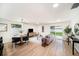 Spacious living room featuring wood floors, a sliding door and neutral decor at 3072 Sugar Bear Trl, Palm Harbor, FL 34684