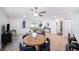 Well-lit living room with wood floors, a ceiling fan and comfortable seating at 3072 Sugar Bear Trl, Palm Harbor, FL 34684