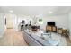Open concept living room with barstool seating and stainless appliances at 3072 Sugar Bear Trl, Palm Harbor, FL 34684