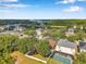 A stunning aerial view displays homes, pool, green trees and landscape, completing a lovely community at 3230 Bellericay Ln, Land O Lakes, FL 34638