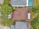 This aerial view captures the home's roof, driveway, backyard pool and green landscaping between neighboring homes at 3230 Bellericay Ln, Land O Lakes, FL 34638