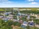 This overhead shot captures the beautiful community, tranquil lake, and homes with pools in the backyards at 3230 Bellericay Ln, Land O Lakes, FL 34638