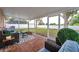 Relaxing screened-in back porch with stylish seating and view of the landscaped backyard at 3230 Bellericay Ln, Land O Lakes, FL 34638