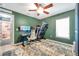 Office room featuring a green wall, desk, ceiling fan, and a treadmill at 3230 Bellericay Ln, Land O Lakes, FL 34638