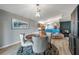 Cozy dining room adjacent to the kitchen with modern pendant lighting fixture at 3230 Bellericay Ln, Land O Lakes, FL 34638