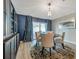 Open dining room with modern decor, including a custom built-in cabinet at 3230 Bellericay Ln, Land O Lakes, FL 34638