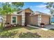 Attractive home featuring a well-kept lawn, manicured landscaping, and a convenient two-car garage at 3230 Bellericay Ln, Land O Lakes, FL 34638
