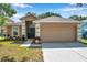 Charming single-story home with a well-manicured lawn, two car garage, and inviting front entrance at 3230 Bellericay Ln, Land O Lakes, FL 34638