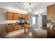 Bright kitchen featuring granite counters, wood cabinets and stylish pendant lighting at 3230 Bellericay Ln, Land O Lakes, FL 34638