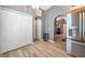 View of the kitchen area featuring stainless steel appliances and access to hallway at 3230 Bellericay Ln, Land O Lakes, FL 34638