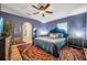 Well-lit main bedroom with stylish design elements, including hardwood floors and a unique rug at 3230 Bellericay Ln, Land O Lakes, FL 34638