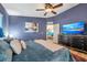 Comfortable main bedroom with custom furniture, modern TV, and neutral decor at 3230 Bellericay Ln, Land O Lakes, FL 34638